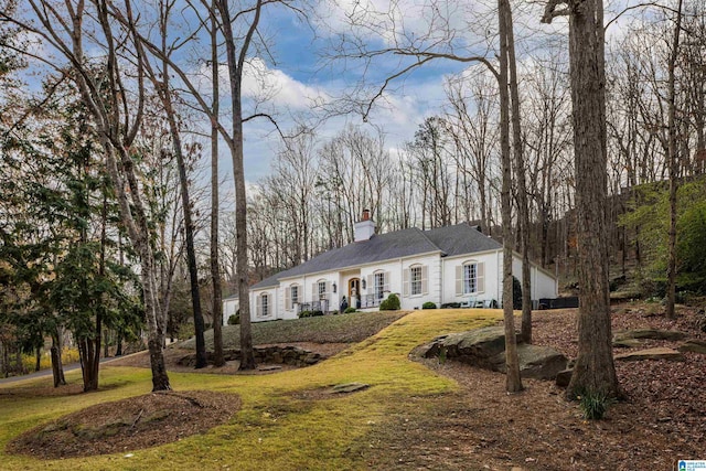 view of front of house with a front lawn and a chimney