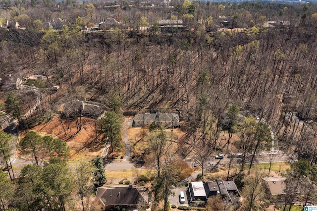 birds eye view of property featuring a view of trees