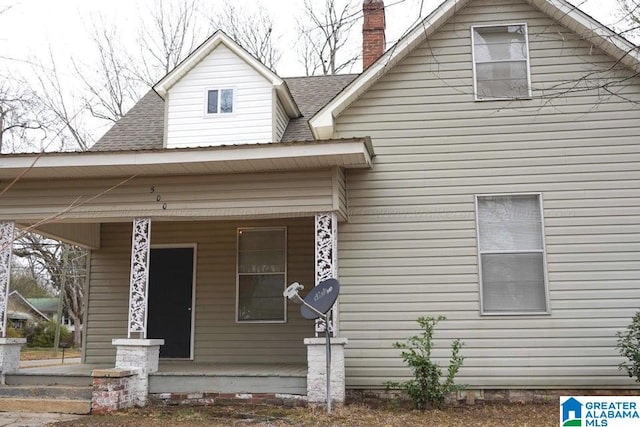 view of front facade with a porch and a shingled roof