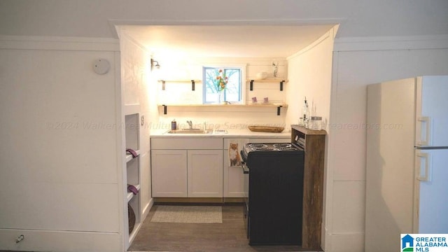 bathroom with wood finished floors and a sink