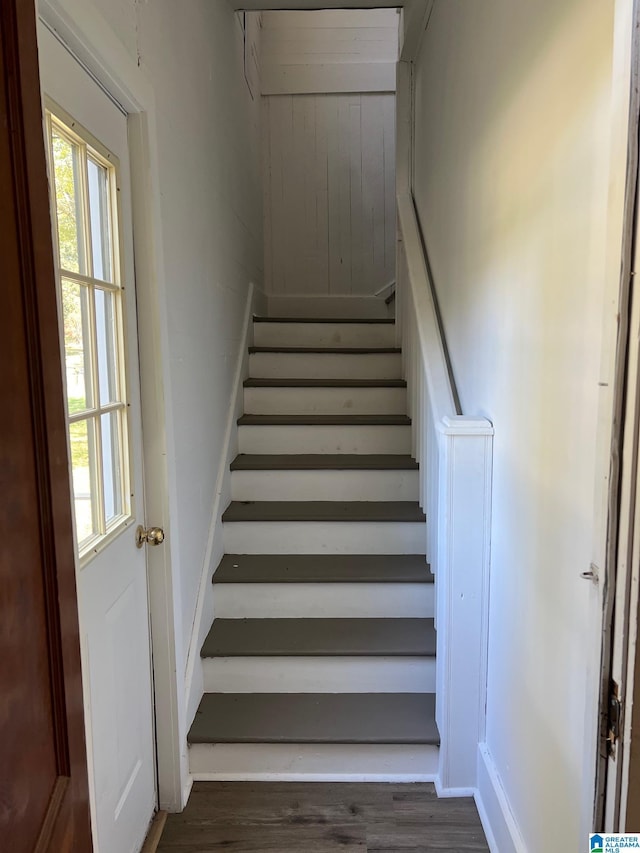 stairway featuring baseboards and wood finished floors