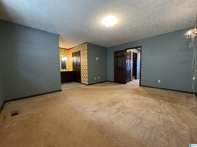 unfurnished room with light carpet, visible vents, and baseboards