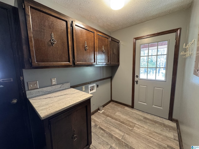 kitchen featuring light countertops, light wood-style flooring, dark brown cabinetry, a textured ceiling, and baseboards