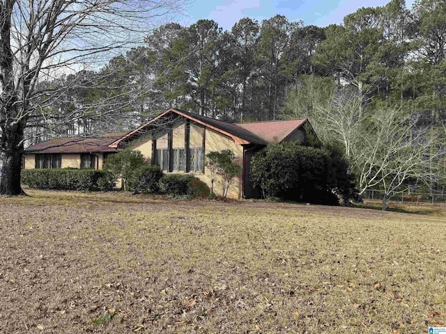 view of property exterior with a lawn