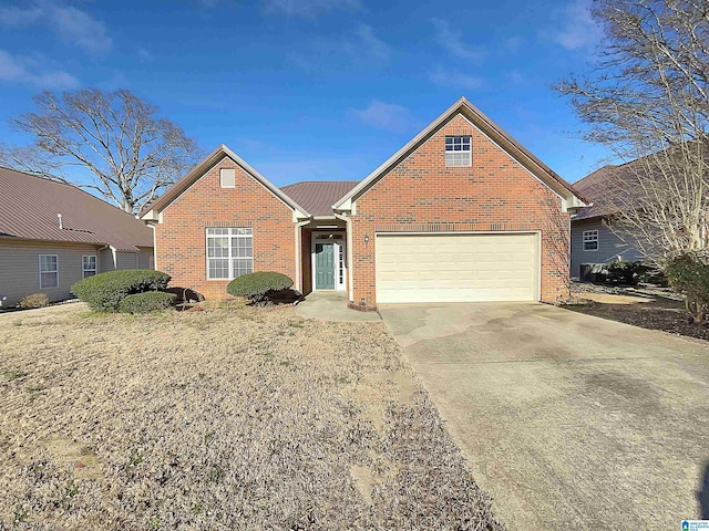 view of front of property featuring driveway, an attached garage, and brick siding