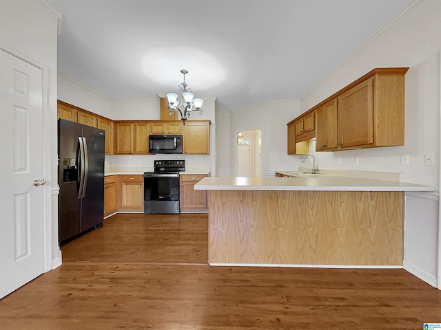 kitchen with black microwave, a peninsula, refrigerator with ice dispenser, electric stove, and dark wood finished floors