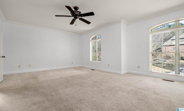 unfurnished room with ornamental molding, visible vents, and light colored carpet