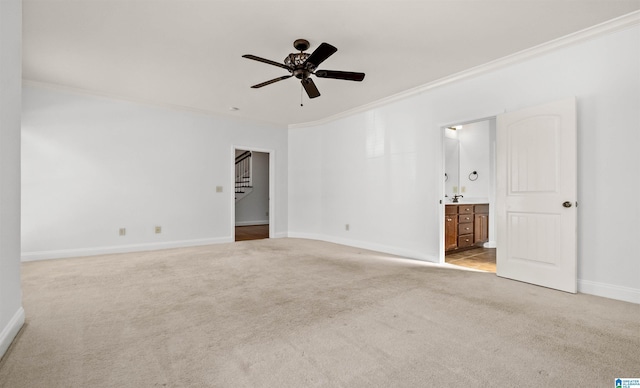 spare room with baseboards, ceiling fan, stairway, crown molding, and carpet flooring