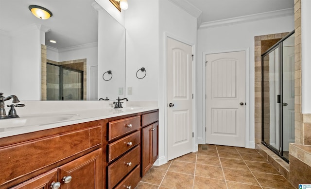 full bathroom featuring a stall shower, ornamental molding, and a sink