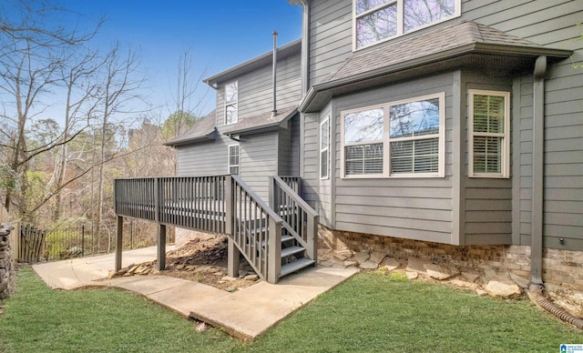 rear view of property with stairs, a shingled roof, fence, and a wooden deck