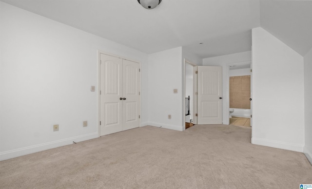 unfurnished bedroom featuring carpet floors, a closet, and baseboards