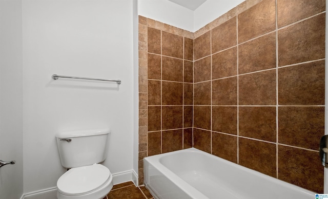 bathroom with toilet, tile patterned flooring, and baseboards