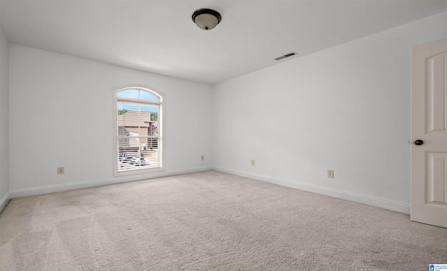 carpeted empty room with baseboards and visible vents