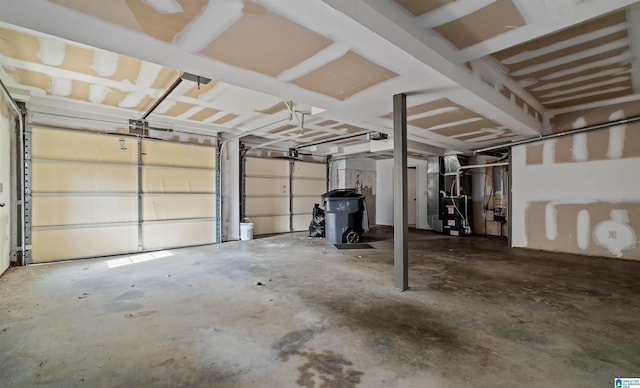 garage featuring heating unit and a garage door opener