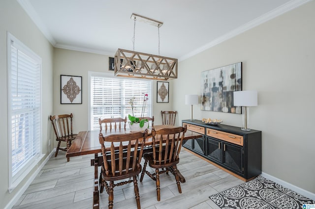 dining space featuring baseboards, ornamental molding, and wood finish floors