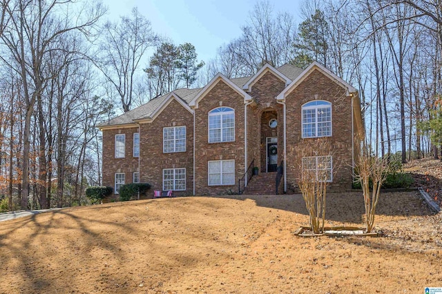 bi-level home featuring brick siding