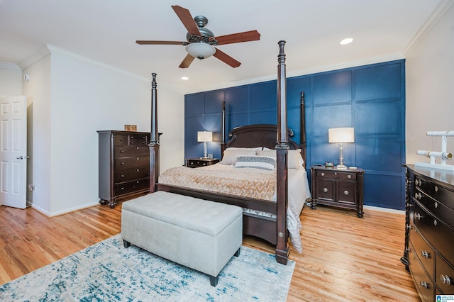 bedroom featuring baseboards, light wood-type flooring, a ceiling fan, and crown molding