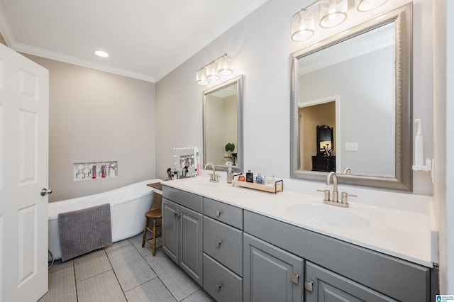 bathroom with double vanity, a soaking tub, a sink, and crown molding