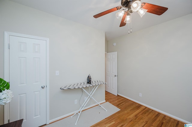 spare room featuring light wood-type flooring and baseboards