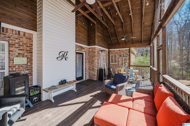 wooden deck featuring ceiling fan and an outdoor living space