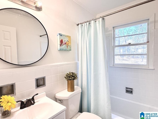 full bathroom featuring shower / tub combo, toilet, ornamental molding, vanity, and tile walls