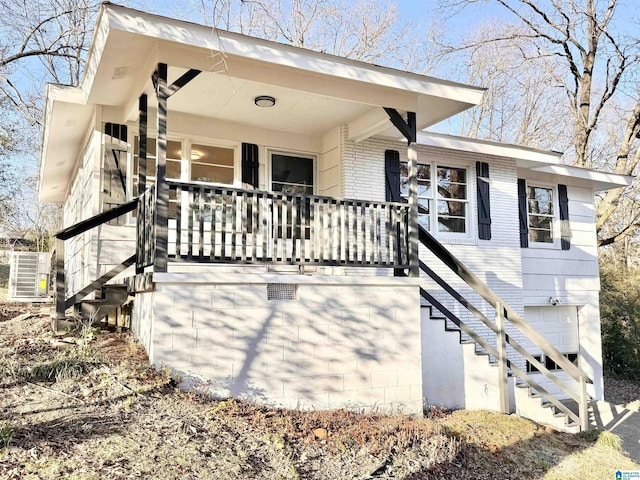 exterior space with brick siding and a porch