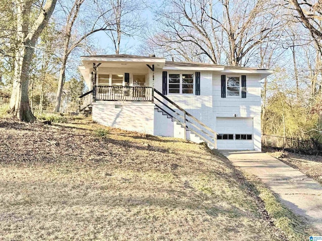 ranch-style home featuring a garage, covered porch, driveway, and stairway