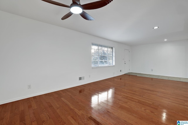 unfurnished room featuring recessed lighting, visible vents, baseboards, and wood finished floors