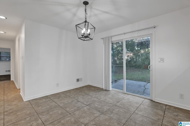 unfurnished dining area featuring baseboards, visible vents, and tile patterned floors