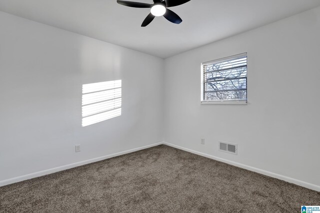 carpeted empty room with a ceiling fan, visible vents, and baseboards