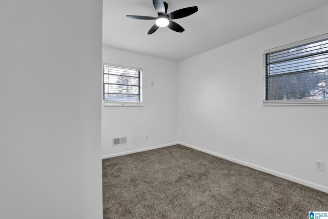 empty room with a ceiling fan, carpet, visible vents, and baseboards