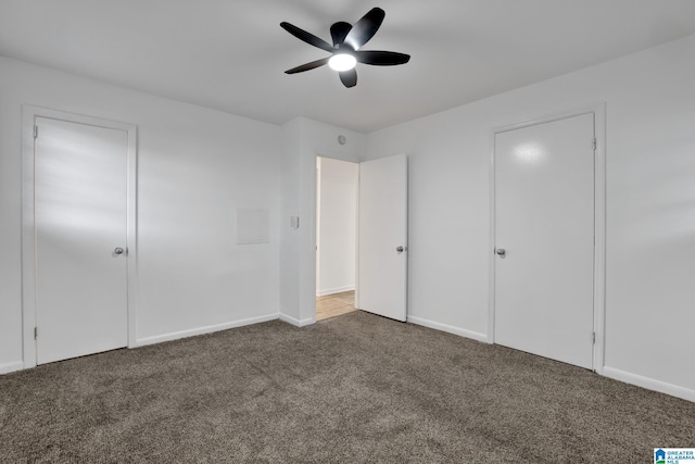 unfurnished bedroom with carpet flooring, ceiling fan, and baseboards