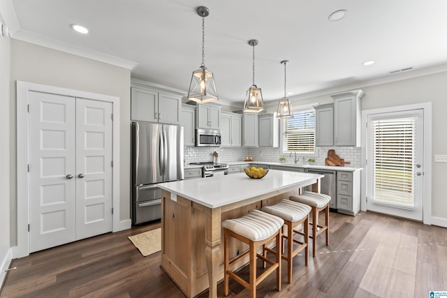 kitchen with light countertops, appliances with stainless steel finishes, gray cabinets, and crown molding