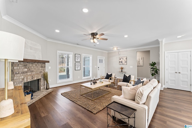 living room featuring ornamental molding, a brick fireplace, ceiling fan, and wood finished floors