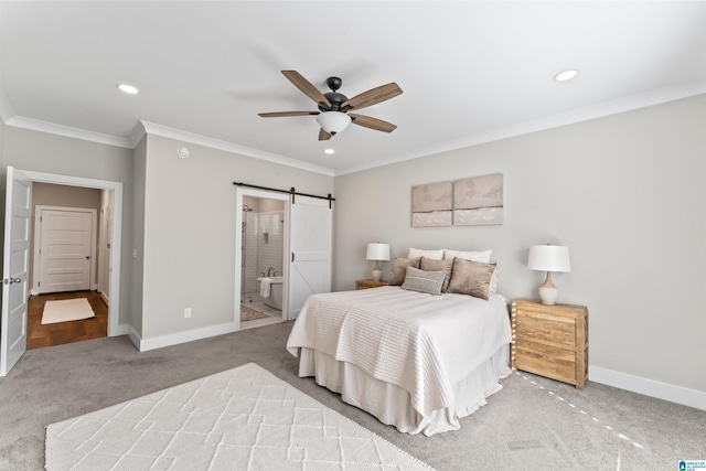 bedroom with crown molding, a barn door, carpet, and baseboards