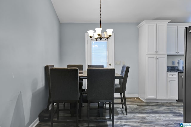 dining space with dark wood-style flooring, baseboards, and an inviting chandelier