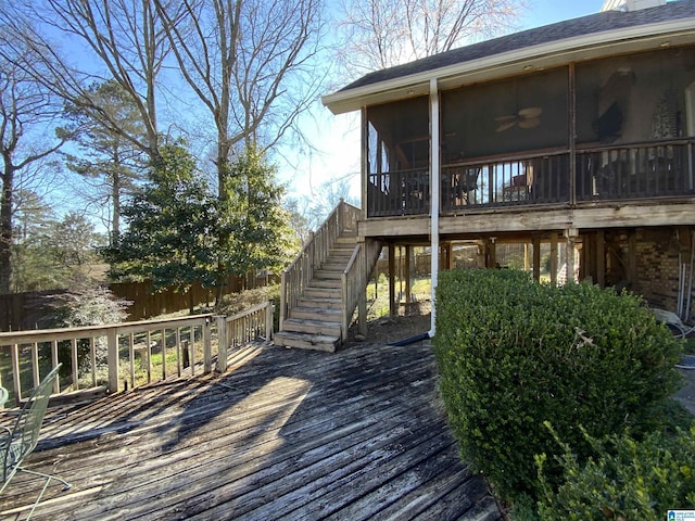 wooden deck featuring stairs and a sunroom