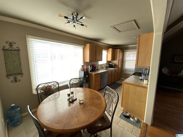 dining area with attic access, crown molding, and baseboards