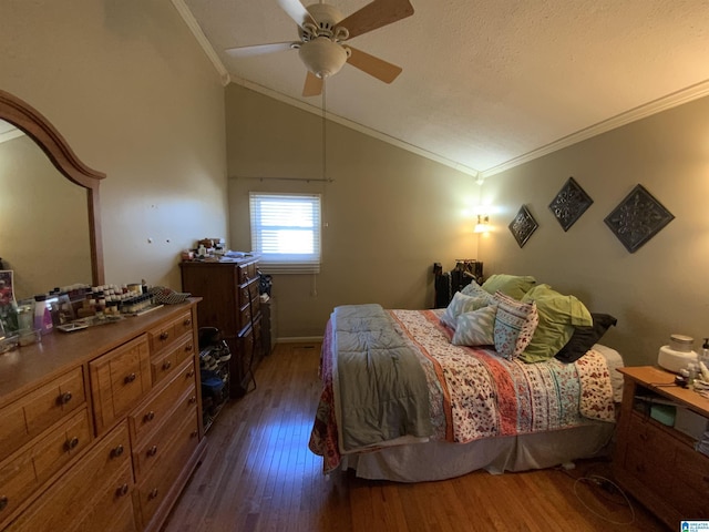 bedroom with crown molding, lofted ceiling, dark wood finished floors, and ceiling fan