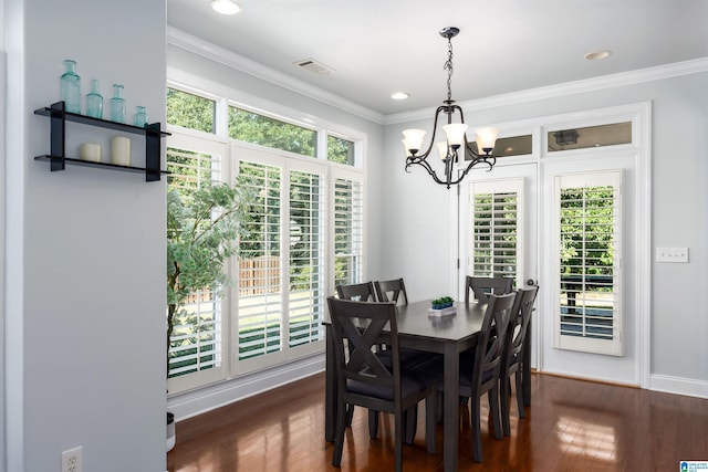 dining room featuring dark wood-style floors, a wealth of natural light, and crown molding