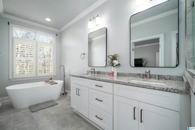 full bathroom featuring a freestanding bath, a sink, and crown molding