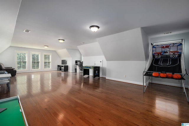 rec room with wood-type flooring, visible vents, vaulted ceiling, and baseboards