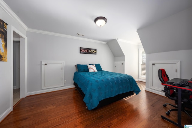 bedroom featuring ornamental molding, visible vents, baseboards, and wood finished floors