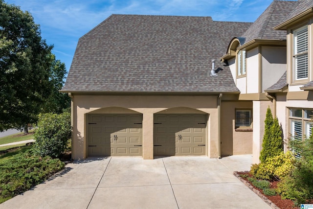 garage featuring concrete driveway