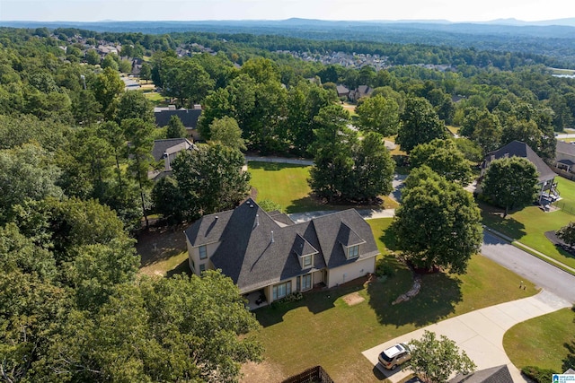 bird's eye view with a wooded view