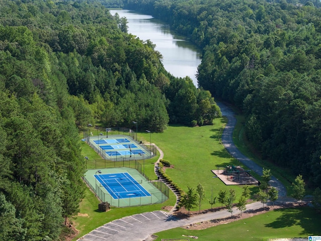 bird's eye view featuring a forest view and a water view