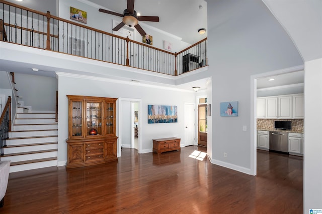 living area featuring baseboards, stairway, dark wood finished floors, and ornamental molding