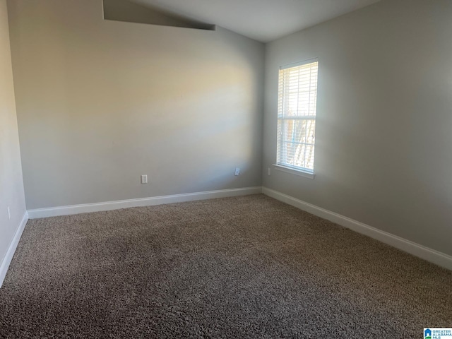 carpeted empty room with baseboards