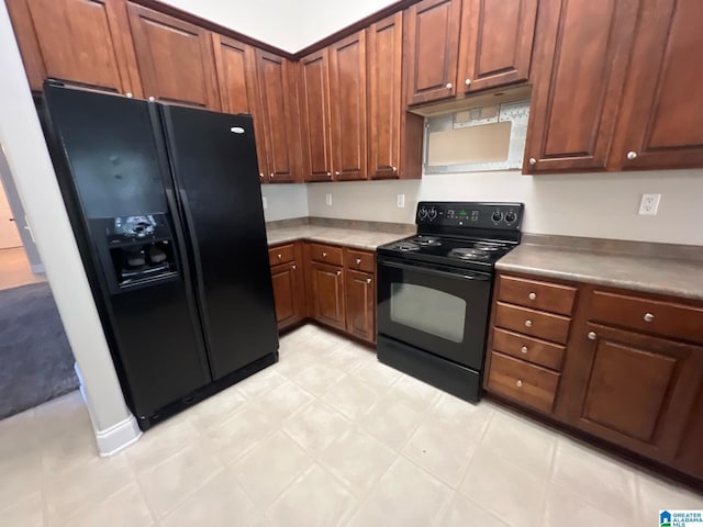 kitchen with light floors, black appliances, and extractor fan