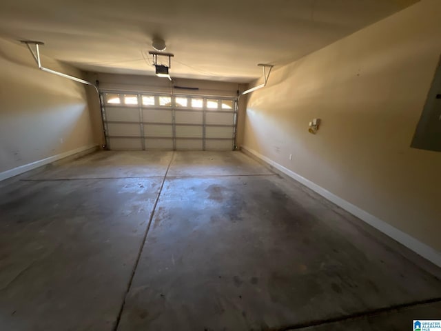 garage with a garage door opener and baseboards